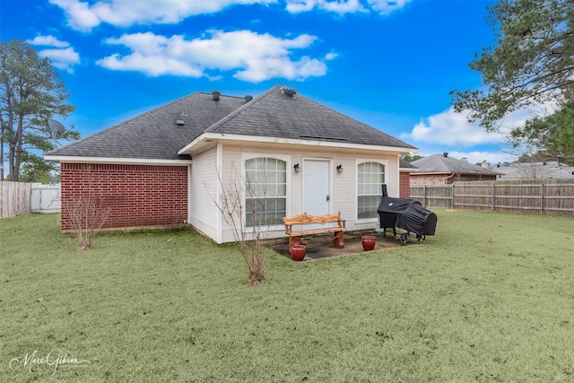 rear view of house with a yard