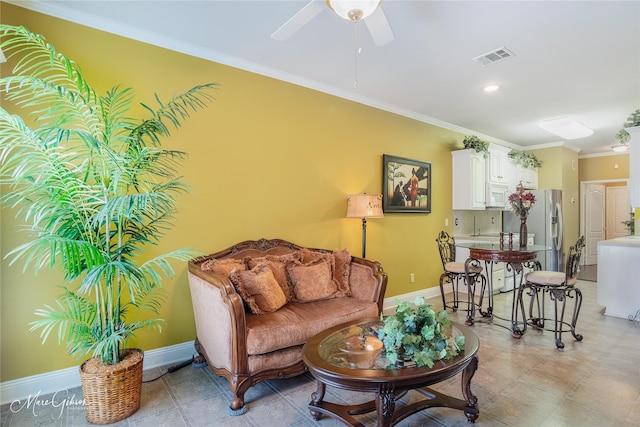 living room featuring ceiling fan and ornamental molding