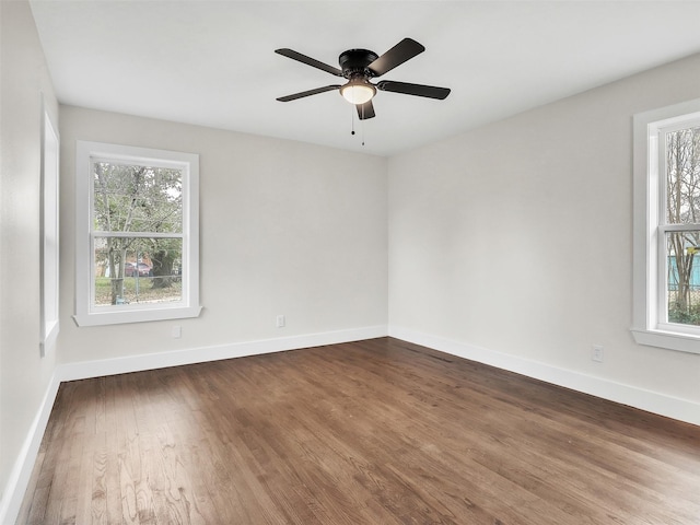 unfurnished room with dark wood-type flooring and ceiling fan