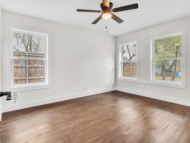 unfurnished room featuring dark hardwood / wood-style flooring and ceiling fan