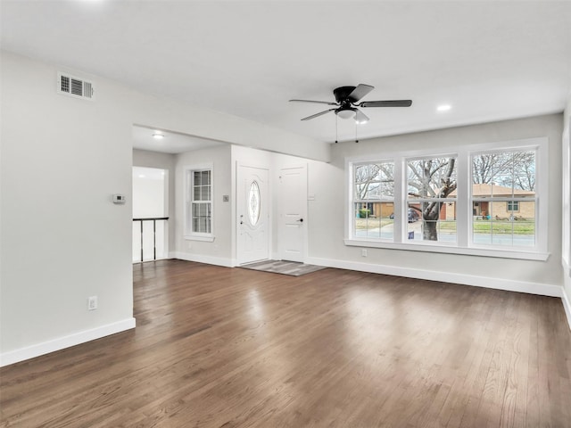 interior space featuring dark wood-type flooring and ceiling fan