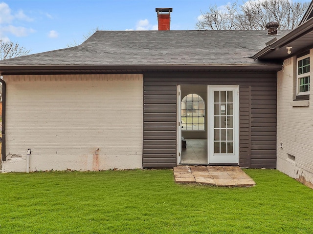 rear view of property with a yard