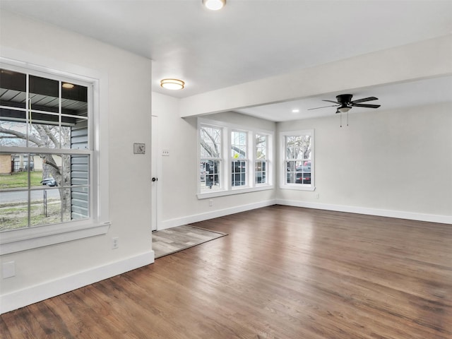 foyer entrance with dark wood-type flooring and ceiling fan