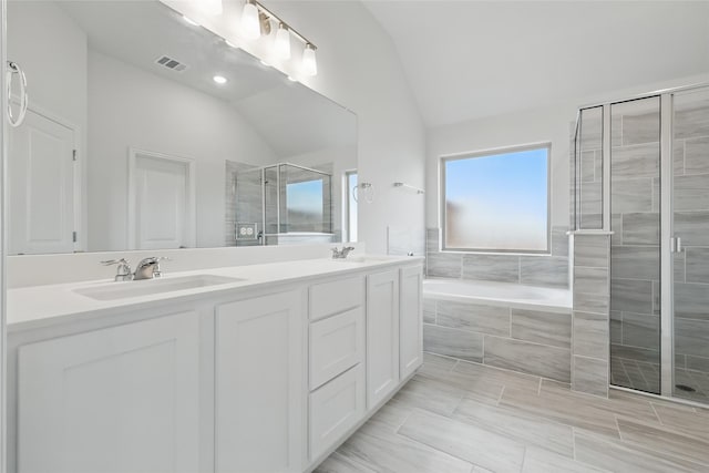 16109 Garden Dr, Celina, TX 75009 - full bath with a garden tub, visible vents, a sink, lofted ceiling, and a stall shower