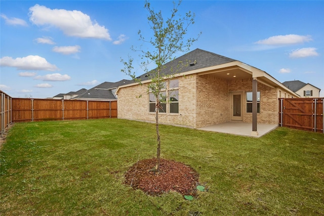 16109 Garden Dr, Celina, TX 75009 - rear view of house with a yard, a patio area, a fenced backyard, and brick siding