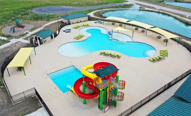 16109 Garden Dr, Celina, TX 75009 - view of swimming pool with a patio area, a water play area, fence, and a water slide