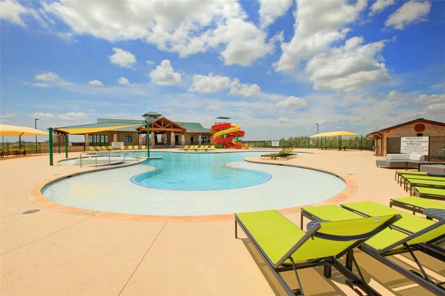 16109 Garden Dr, Celina, TX 75009 - pool featuring a patio area, a water play area, fence, and a water slide