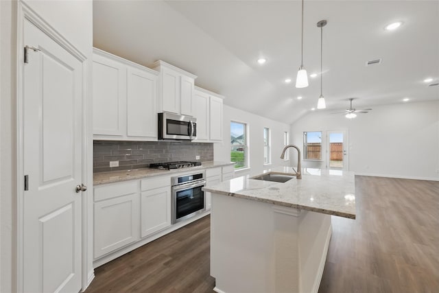16109 Garden Dr, Celina, TX 75009 - kitchen with backsplash, white cabinetry, a sink, stainless steel appliances, and dark wood-style floors