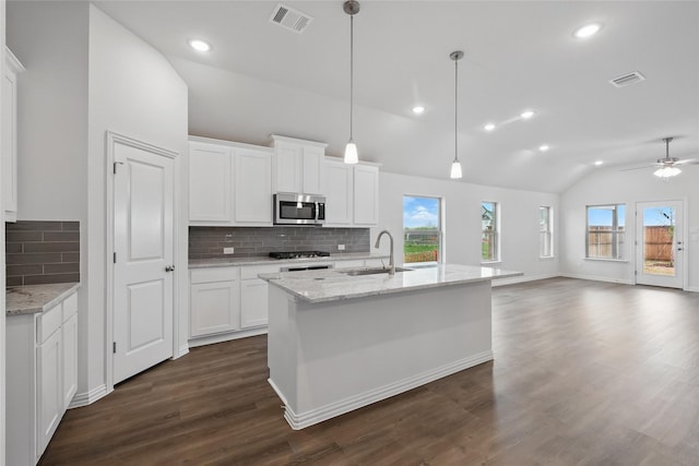 16109 Garden Dr, Celina, TX 75009 - kitchen featuring a sink, visible vents, stainless steel microwave, and lofted ceiling