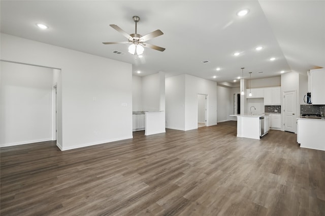 16109 Garden Dr, Celina, TX 75009 - unfurnished living room with a ceiling fan, visible vents, recessed lighting, a sink, and dark wood-style floors