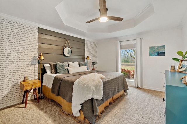 carpeted bedroom with baseboards, crown molding, and a tray ceiling