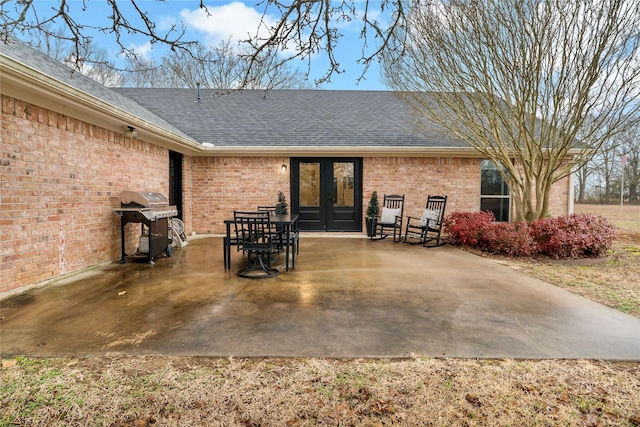 exterior space with a grill and french doors