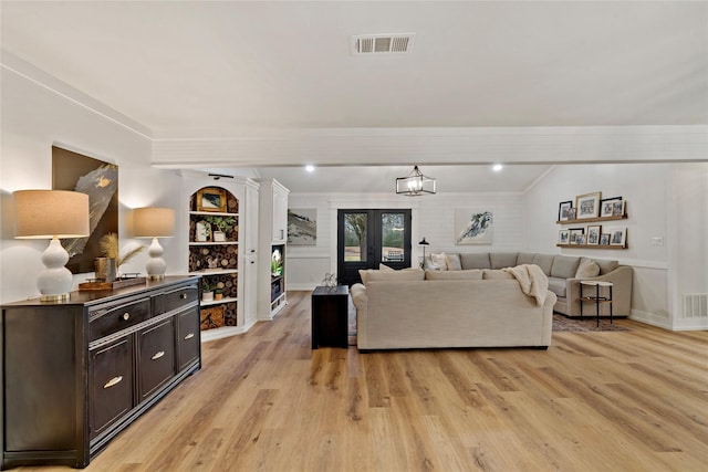living room featuring visible vents, beam ceiling, and light wood-style floors
