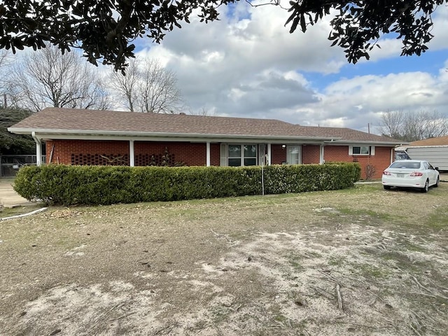 ranch-style home featuring brick siding