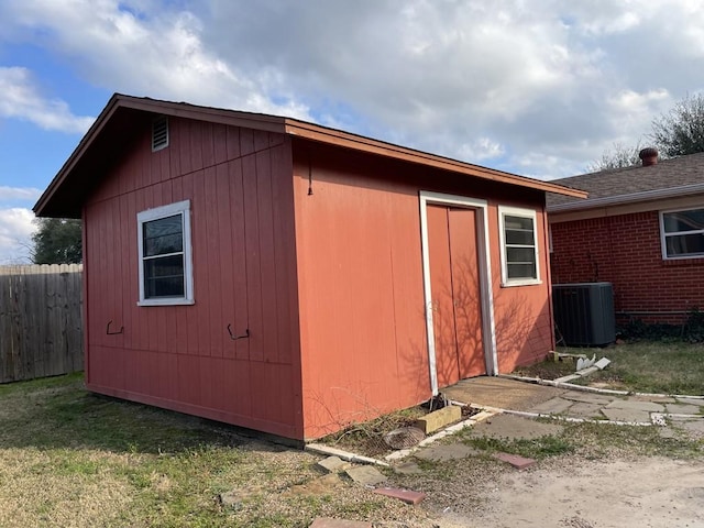 view of outbuilding featuring an outbuilding, cooling unit, and fence