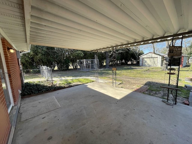 view of patio / terrace with an outbuilding and fence