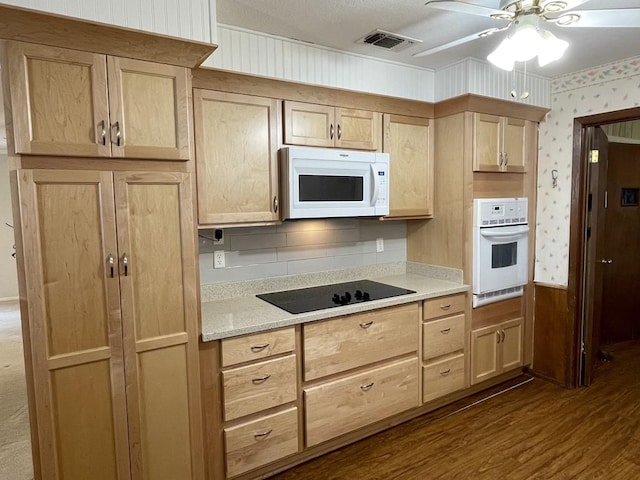 kitchen featuring white appliances, wallpapered walls, visible vents, dark wood finished floors, and light brown cabinets