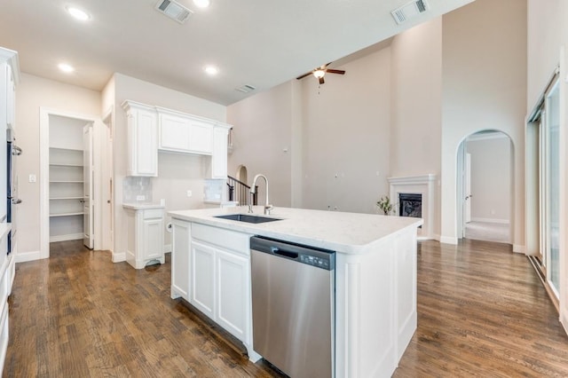 kitchen with dishwasher, white cabinets, and an island with sink