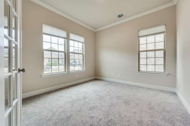 carpeted spare room with ornamental molding and french doors