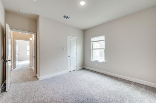 unfurnished bedroom featuring light carpet