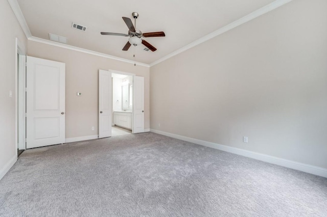 unfurnished bedroom with ceiling fan, light colored carpet, ornamental molding, and ensuite bathroom