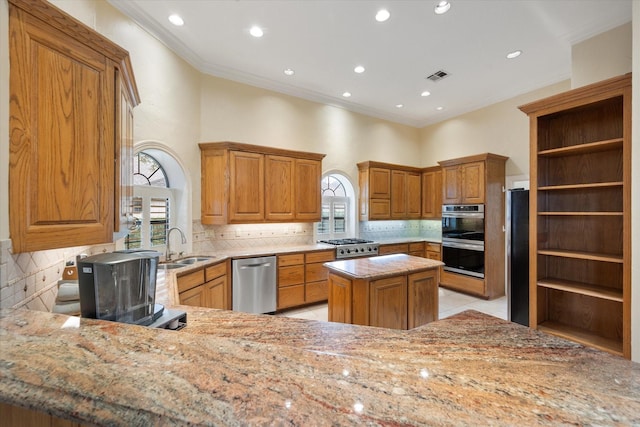 1604 Bridle Path, Corsicana, TX 75110 - kitchen with a peninsula, brown cabinets, open shelves, ornamental molding, and baseboards