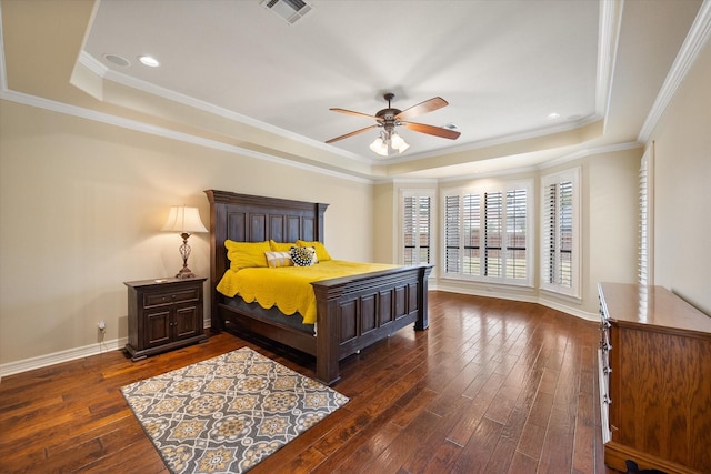 bedroom featuring dark hardwood / wood-style flooring, crown molding, a raised ceiling, and ceiling fan