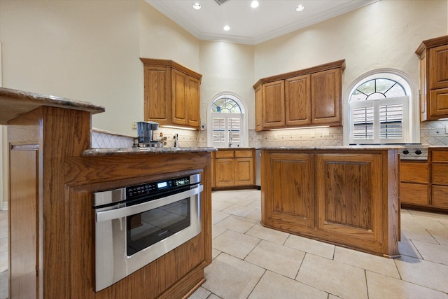 1604 Bridle Path, Corsicana, TX 75110 - kitchen with open shelves, stainless steel appliances, a center island, decorative backsplash, and light tile patterned flooring