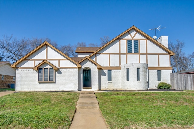 tudor home with a front yard