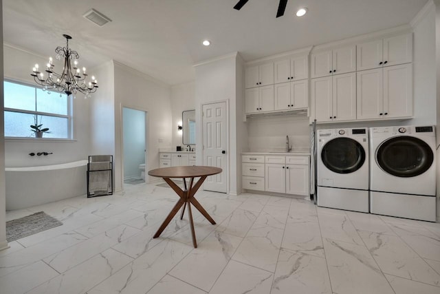 clothes washing area with sink, cabinets, ornamental molding, washing machine and clothes dryer, and ceiling fan