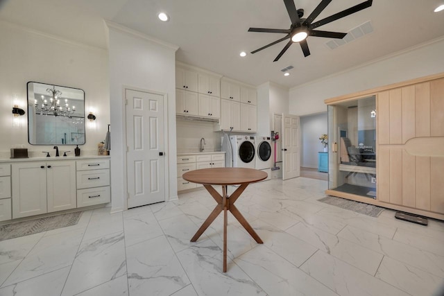 laundry room with ornamental molding, sink, ceiling fan, and independent washer and dryer