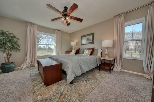 carpeted bedroom featuring ceiling fan and multiple windows