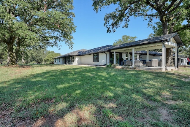 back of house featuring a yard and a patio area