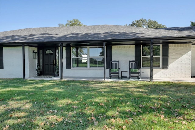 entrance to property featuring a yard