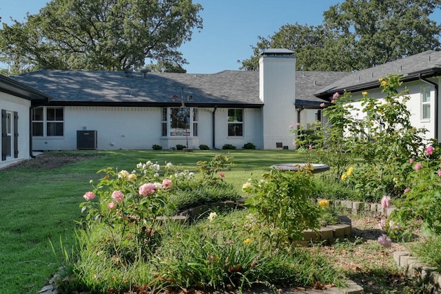 back of house with a yard and central AC unit