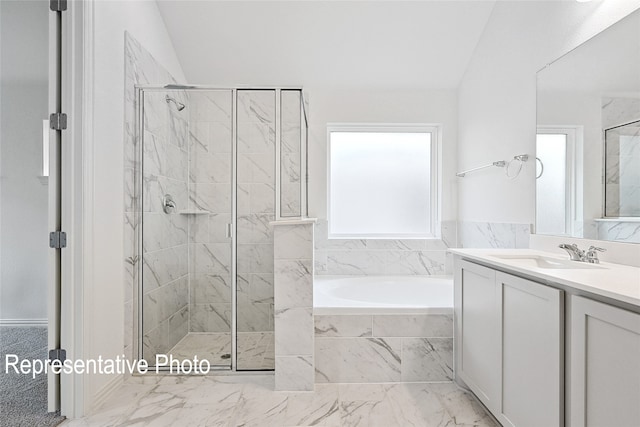 bathroom featuring vaulted ceiling, vanity, and separate shower and tub