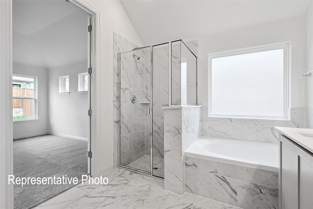 bathroom featuring vanity, independent shower and bath, and vaulted ceiling