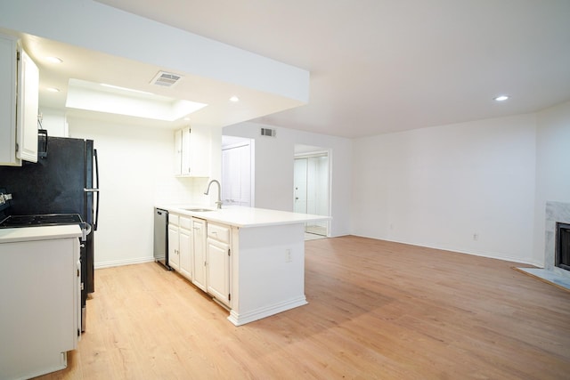 kitchen featuring dishwasher, sink, and white cabinets