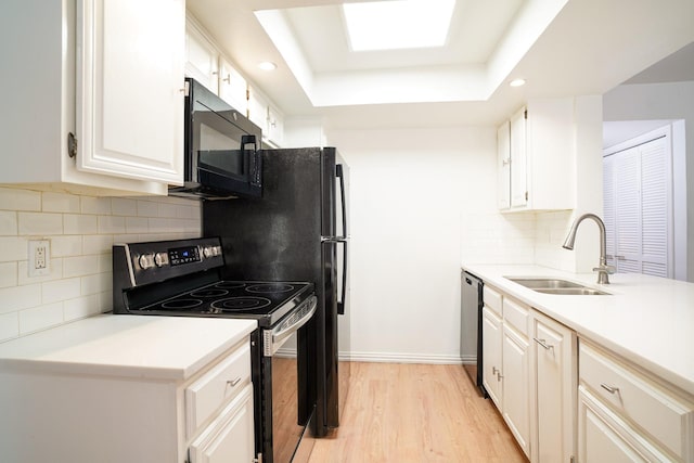 kitchen with dishwasher, white cabinetry, sink, light hardwood / wood-style floors, and electric stove