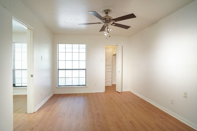 empty room with light hardwood / wood-style flooring and ceiling fan