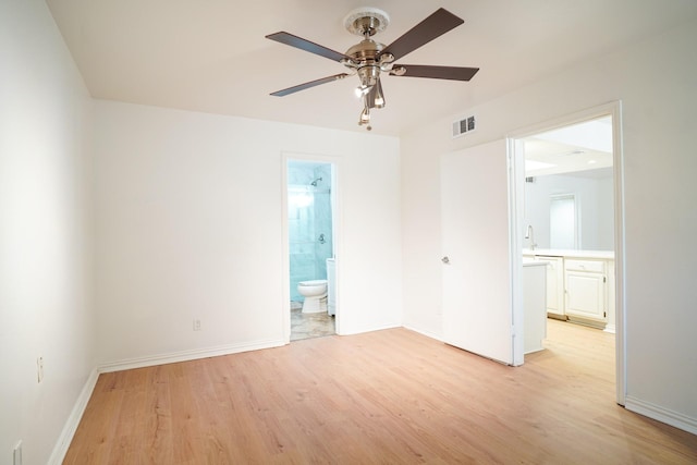 spare room featuring ceiling fan and light wood-type flooring