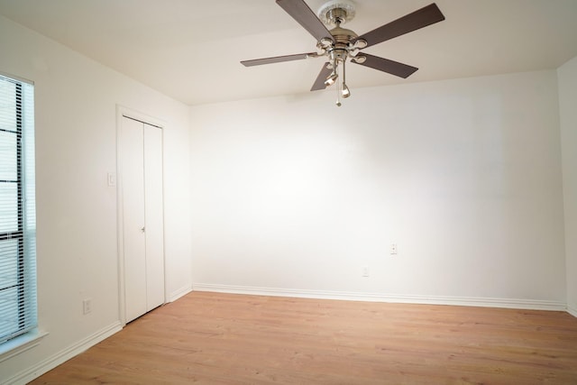 unfurnished bedroom featuring ceiling fan, light hardwood / wood-style floors, and a closet