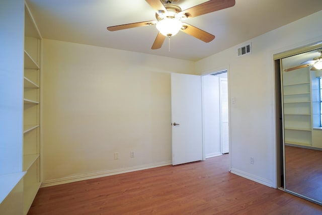 spare room with hardwood / wood-style floors and ceiling fan