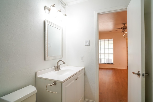 bathroom with vanity, ceiling fan, hardwood / wood-style floors, and toilet