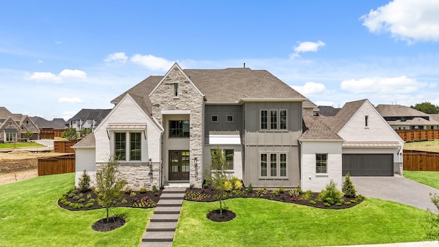 french provincial home with french doors, a garage, and a front yard