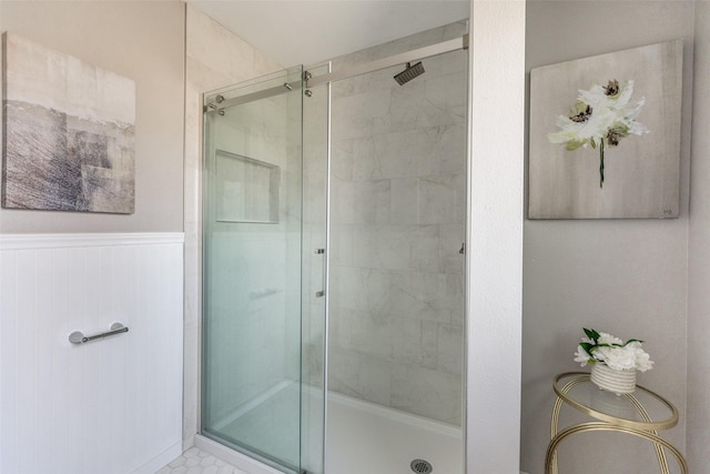 bathroom featuring a shower with shower door