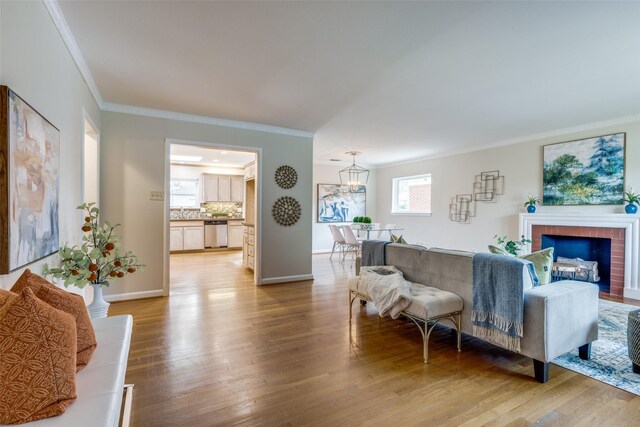 living room with crown molding, a fireplace, and hardwood / wood-style floors