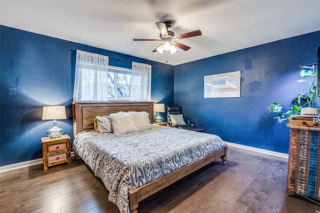 bedroom with dark hardwood / wood-style flooring and ceiling fan