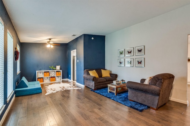 living room featuring ceiling fan and wood-type flooring