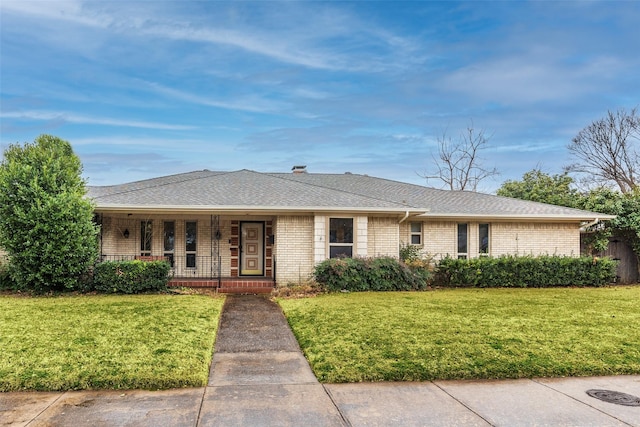 ranch-style house featuring a porch and a front yard